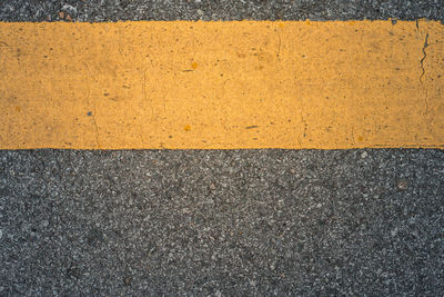 Full frame shot of yellow lines on road