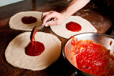 Close-up of hand holding pizza