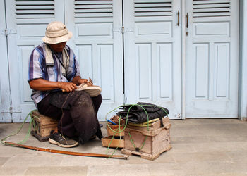 Man sitting in front of door