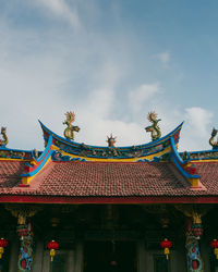 Low angle view of temple and building against sky