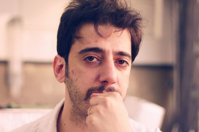 Close-up portrait of young man at home