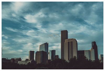 Modern buildings in city against sky