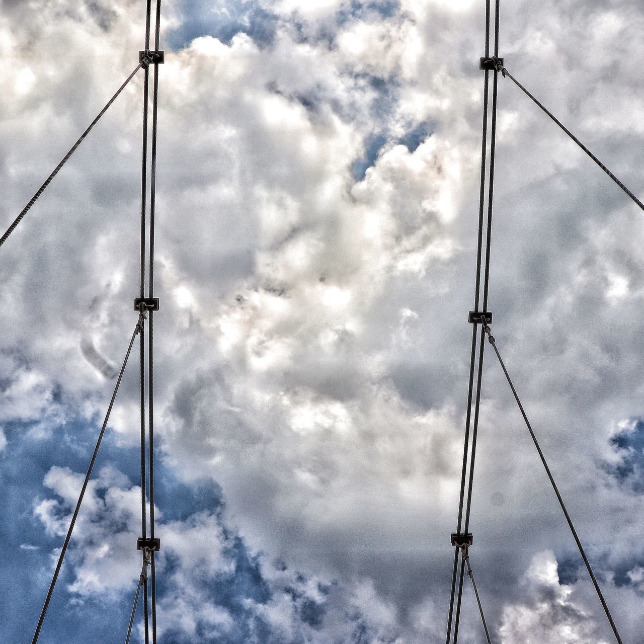 LOW ANGLE VIEW OF ELECTRICITY POLE AGAINST SKY