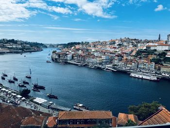 High angle view of townscape by sea against sky