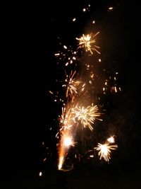 Low angle view of firework display at night