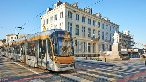 View of train against buildings in city