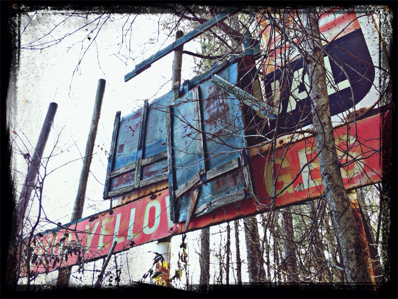 text, transfer print, western script, auto post production filter, communication, transportation, built structure, low angle view, architecture, graffiti, day, building exterior, outdoors, sky, no people, mode of transport, sign, non-western script, metal, warning sign