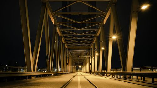 Illuminated bridge at night
