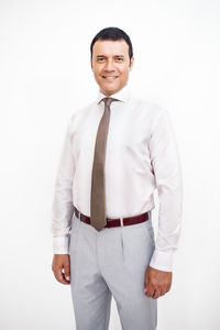 Portrait of smiling man standing against white background