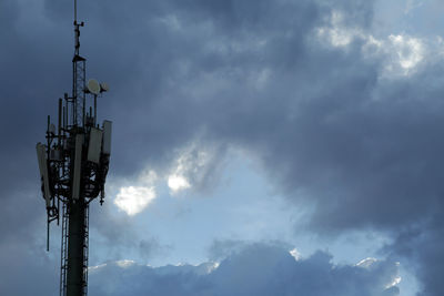 Low angle view of communications tower against sky