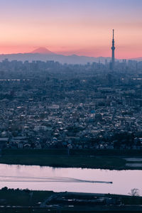 Aerial view of buildings in city during sunset