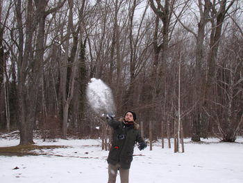 Man throwing snow on field
