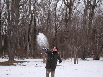 Full length of man on snow covered trees