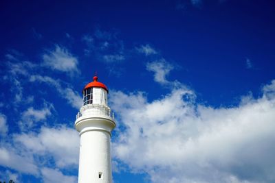Low angle view of lighthouse against blue sky