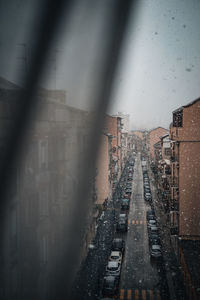 Buildings seen through glass window during snowing