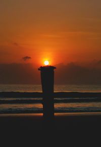 Scenic view of sea against orange sky during sunset