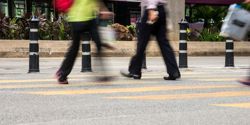 Low section of man and woman walking in city