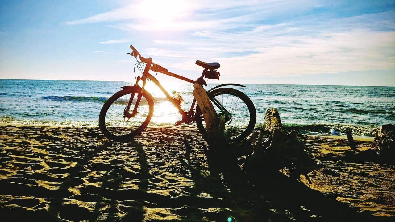 BICYCLE ON BEACH AGAINST SEA