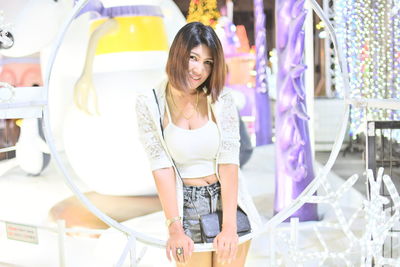 Portrait of smiling young woman standing in store