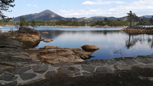 Scenic view of lake and mountains against sky