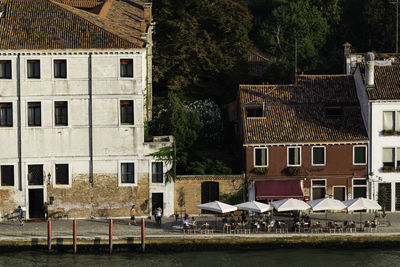 Houses by buildings in town