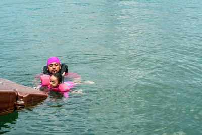 High angle view of woman swimming in sea