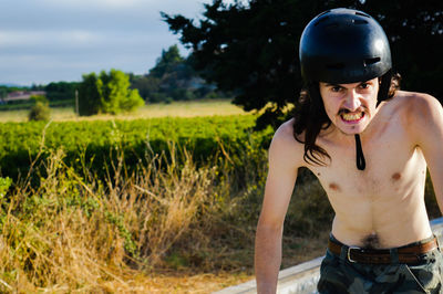 Guy with a bycicle helmet making a weird face 