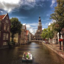 People in temple against sky in city