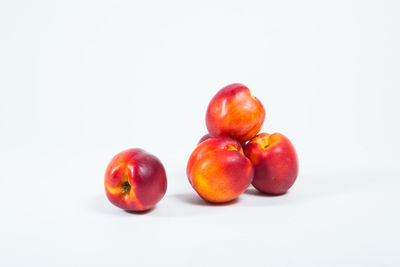 Close-up of nectarines against white background