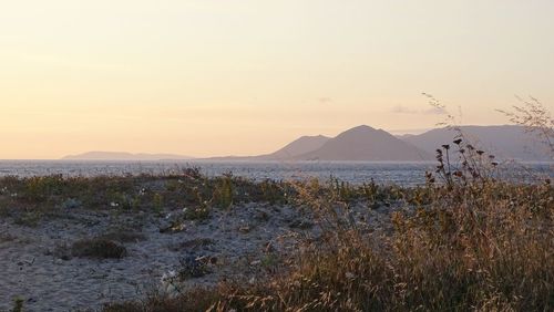 Scenic view of land against sky during sunset