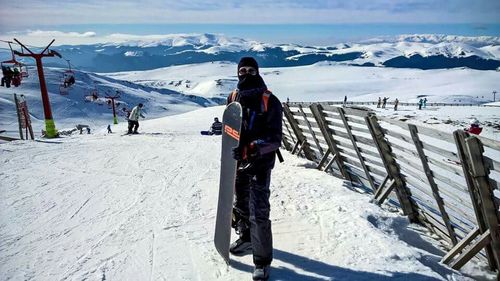 Tourists on snow covered mountain