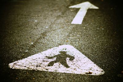 Close-up of arrow symbol on road