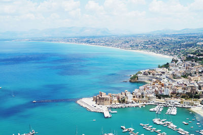 High angle view of sea and buildings against sky