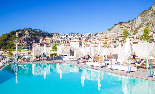 View of swimming pool against clear blue sky