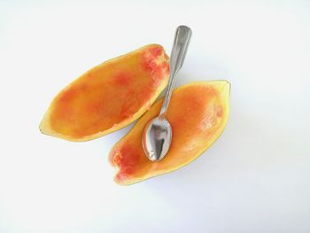 A slice of papaya with spoon