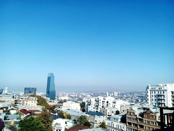 High angle view of buildings against clear blue sky