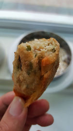 Close-up of hand holding burger