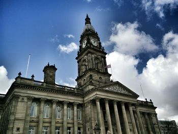 Low angle view of building against cloudy sky