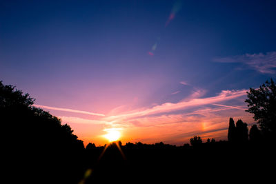 Silhouette trees against sky during sunset