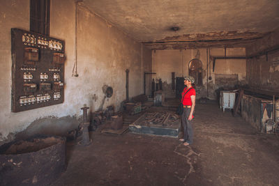 Woman standing in abandoned building