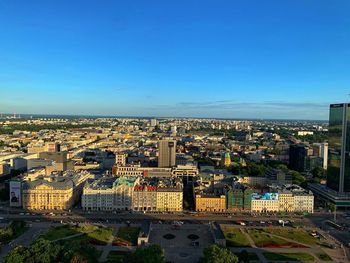 High angle view of buildings against clear blue sky