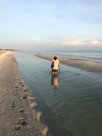 Rear view of woman at beach