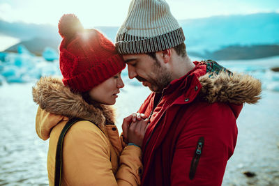 Midsection of friends in park during winter