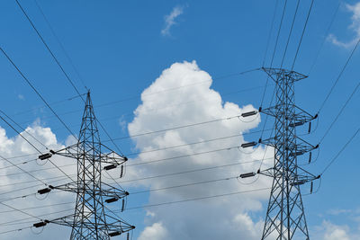 Low angle view of electricity pylon against sky