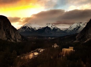 Scenic view of snowcapped mountains against sky during sunset