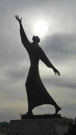 Low angle view of statue against cloudy sky