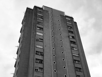 Low angle view of building against cloudy sky