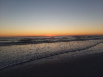 Scenic view of sea against clear sky at sunset