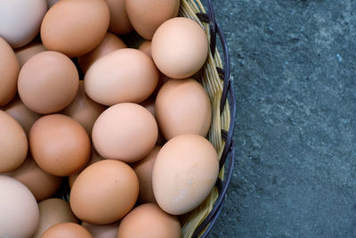 High angle view of brown eggs in basket on table
