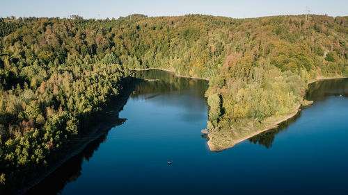 Reflection of trees in lake against sky